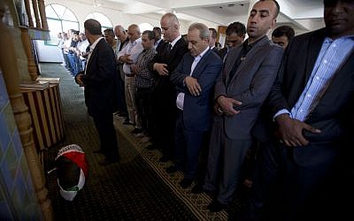 Palestinian Prime Minister Rami Hamdallah, front, prays over the body of one-and-a-half year old boy, Ali Dawabsheh, during his funeral in Duma village near the West Bank city of Nablus, Friday, July 31, 2015. The toddler was burned to death when suspected Jewish assailants set fire to two Palestinian homes in the West Bank village early Friday. (AP Photo/Majdi Mohammed)