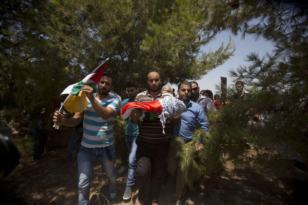 Palestinians carry the body of one-and-a-half year old Ali Dawabsha during his funeral in Duma village near the West Bank city of Nablus, Friday, July 31, 2015. The infant was burned to death in an apparent 'price tag' attack by Jewish terrorists. (AP Photo/Majdi Mohammed)