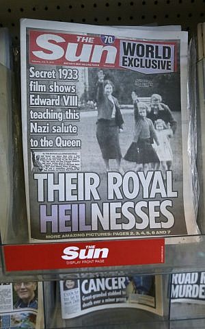 A row of newspapers on display including a paper with a photo of Britain's Queen Elizabeth as a child giving a Nazi salute, in a shop, in London, Saturday July 18, 2015. (AP Photo/Tim Ireland)