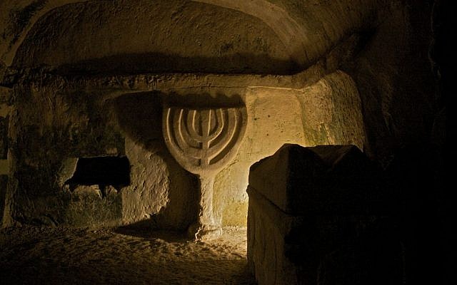 An emblem of a menorah carved in the stone, inside a structure at Beit She'arim National Park, an archaeological site in the Lower Galilee. (Doron Horowitz/Flash90)