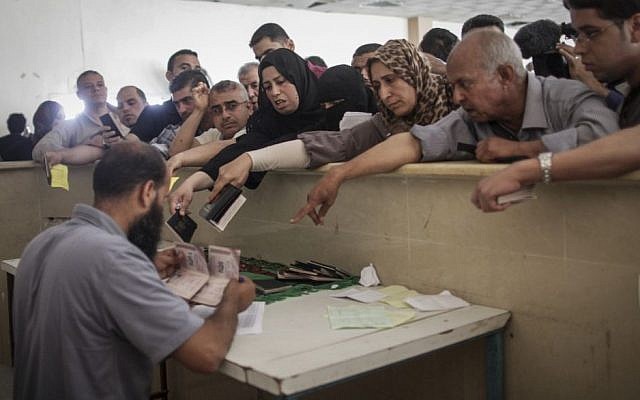 Palestinians gather at the Rafah Border Crossing in the southern Gaza Strip, as they await permission to enter Egypt, June 12, 2015. (Flash90/Aaed Tayeh)