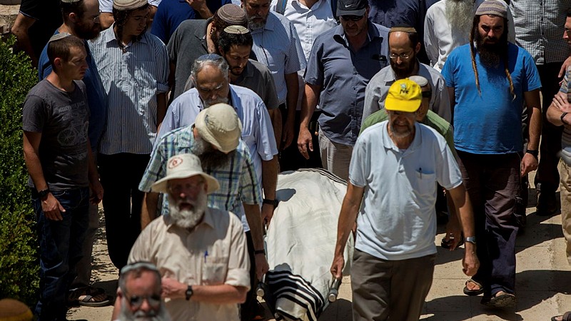 Family and friends carry the body of Malachy Moshe Rosenfeld, 25, during his funeral at Kochav Hashahar in the West Bank, on July 01, 2015. (Yonatan Sindel/Flash90) 