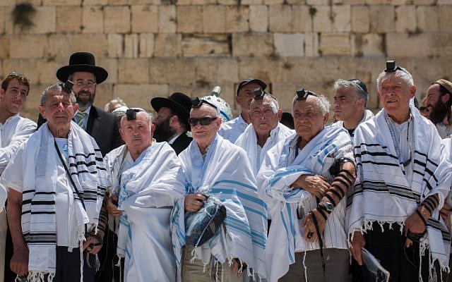 Holocaust survivors pose for a photo after celebrating their belated bar mitzvah at the Western Wall in Jerusalem's Old City, on July 13, 2015. (Yonatan Sindel/Flash90)
