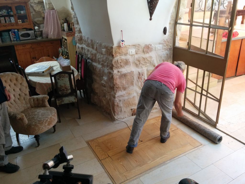 Tal Shimoni reveals the entrance to a first century Jewish ritual bath in his home in Ein Karem, on July 1, 2015. (Ilan Ben Zion/Times of Israel staff)