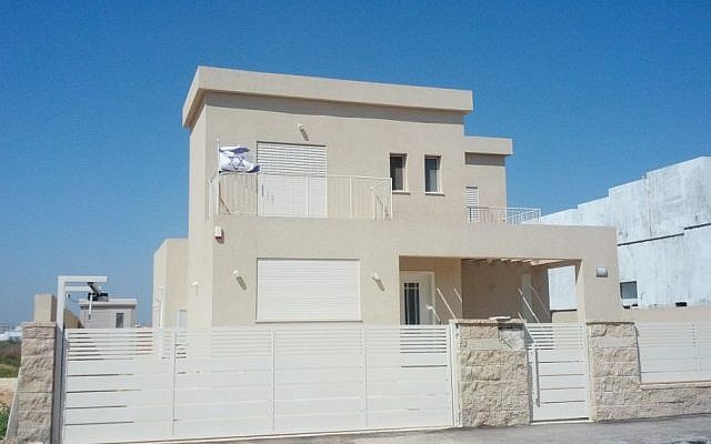 After a decade in a caravan, the Israeli family moved into this spacious two story home in Beer Ganim this past spring. Hanging the flag was the first thing they did. (Melanie Lidman/Times of Israel)