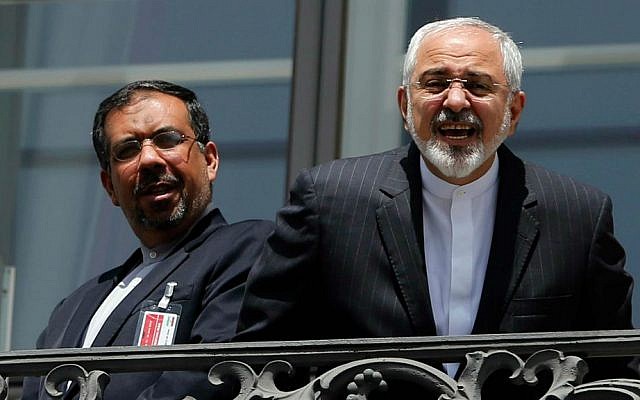 Iranian Foreign Minister Mohammad Javad Zarif (right), talks to a journalist from a balcony of the Palais Coburg Hotel in Vienna, Austria, on July 10, 2015. (Carlos Barria/Pool via AP)