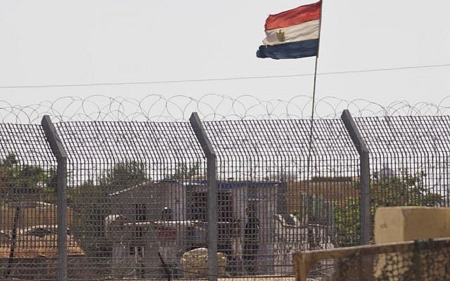Illustrative: An Egyptian military officer keeps watch at a post in Egypt's northern Sinai Peninsula, as seen from the Israel-Egypt border, in the village of Kerem Shalom in southern Israel, July 1, 2015. (AP/Ariel Schalit)