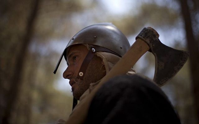 An Israeli member of a knight club gets ready for the reenactment of the Battle of Hattin in Lavi Forest, northern Israel, July 4, 2015 (AP/Oded Balilty)