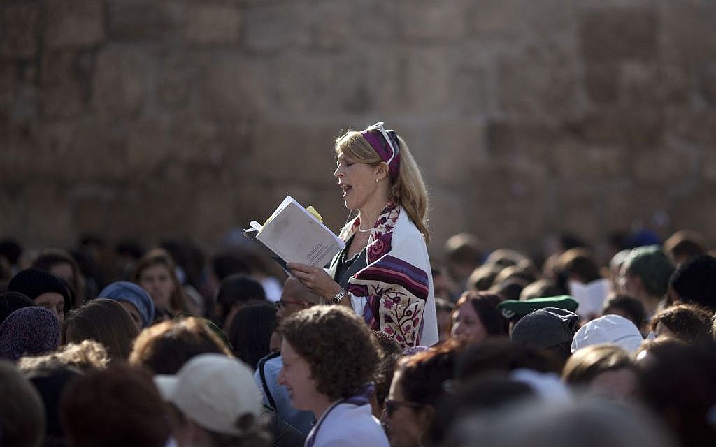 In this Monday, Nov. 4, 2013, file photo, a Jewish woman wears a prayer shawl as she prays at the Western Wall, the holiest site where Jews can pray in Jerusalem's Old City. (AP Photo/Ariel Schalit, File)