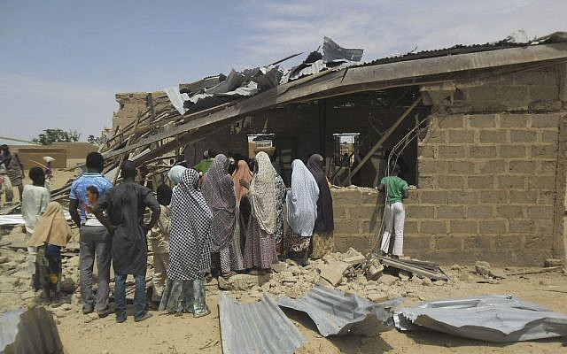 People gather at the site of a suicide bomb attack at Redeem Christian Church in Potiskum, Nigeria, which has been blamed on Boko Haram, July 5, 2015. (Adamu Adamu/AP Photo)