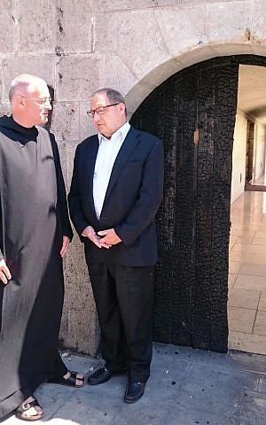 Anti-Defamation League officials visit the Church of the Multiplication of the Loaves and Fishes in Tabgha, after it was damaged by arson. Pictured: Abraham Foxman with Father Mathias Karl, a German monk and one of the heads of the church, June 30, 2015. (Courtesy)
