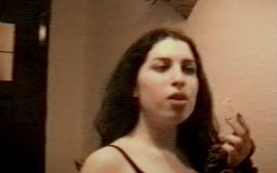 A scene from "Amy," showing Winehouse as a carefree 14-year-old singing Happy Birthday to a close friend (screen capture: YouTube)