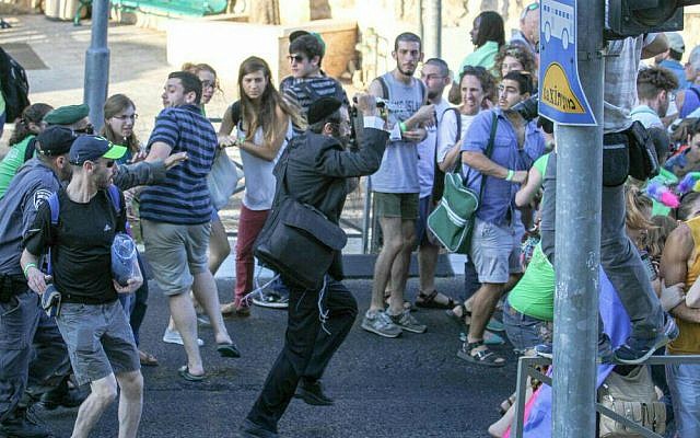Participants in the gay pride parade in Jerusalem flee stabber Yishai Schlissel, July 30, 2015. (Photo: Koby Shotz)