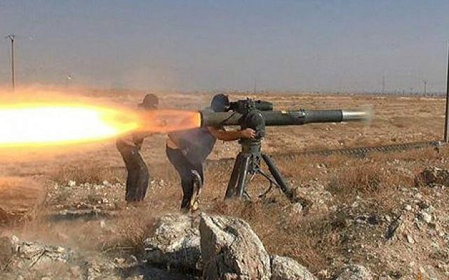 In this picture released on June 26, 2015, by a website of Islamic State militants, Islamic State militants fire an anti-tank missile in Hassakeh, northeast Syria. (Militant website via AP)