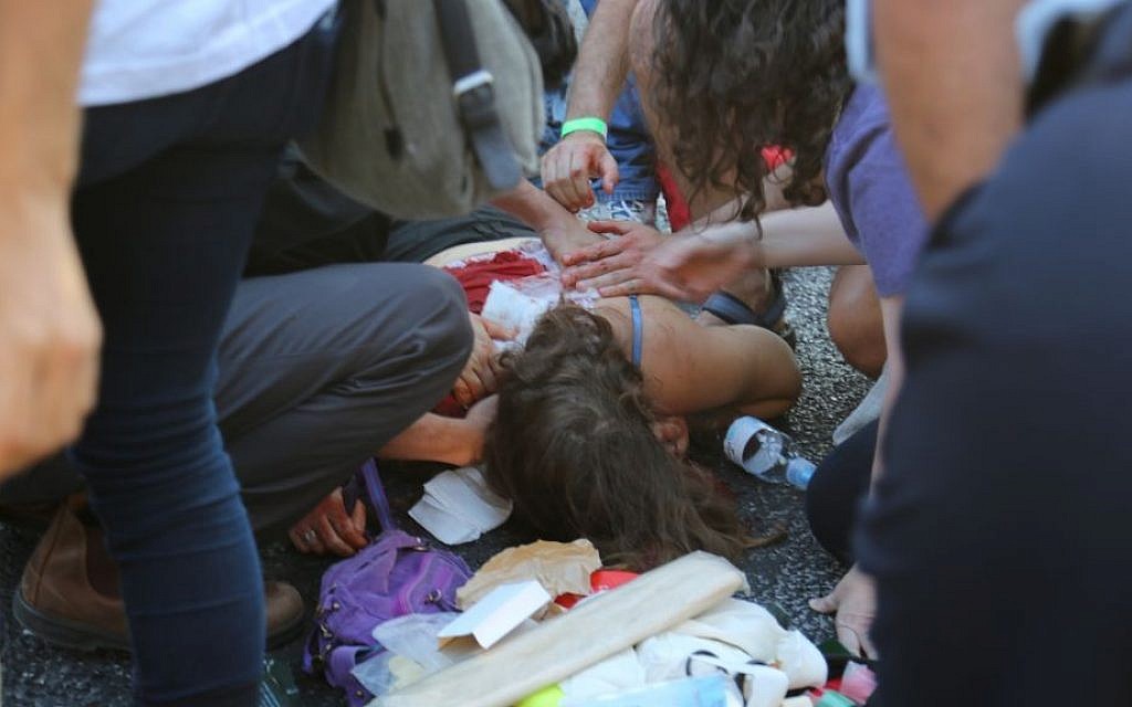 An injured woman after a stabbing at the annual Jerusalem Pride Parade on July 30, 2015. (Eric Cortellessa/Times of Israel)