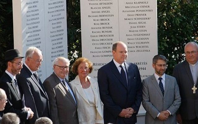 Prince Albert II, 3rd right, stands with French Nazi hunter Serge Klarsfeld, 3rd left, and his wife Beate, center, after unveiling a monument to Jews deported from the Riviera principality during World War II, as part of a larger effort to shed light at last on a troubling chapter in the countrys history, in a cemetery in Monaco, Thursday, Aug. 27, 2015. (Claude Paris/AP)