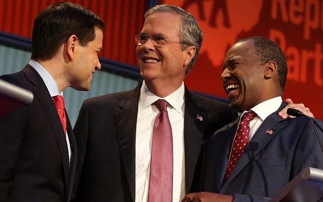 Republican presidential candidates (from left) Marco Rubio, Jeb Bush and Ben Carson talk during a break during the first Republican presidential debate at the Quicken Loans Arena in Cleveland, Thursday, Aug. 6, 2015. (AP Photo/Andrew Harnik)