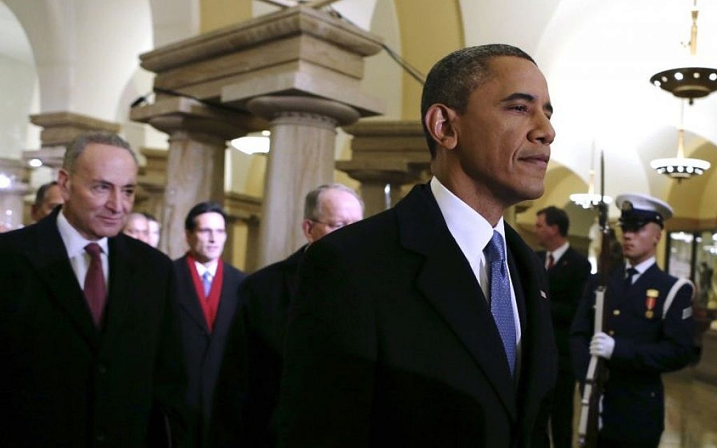 President Barack Obama, followed by Sen. Charles Schumer, D-N.Y., walks through the Capitol in Washington, Monday, Jan. 21, 2013, for his ceremonial swearing-in ceremony during the 57th Presidential Inauguration. (AP Photo/Molly Riley, Pool)