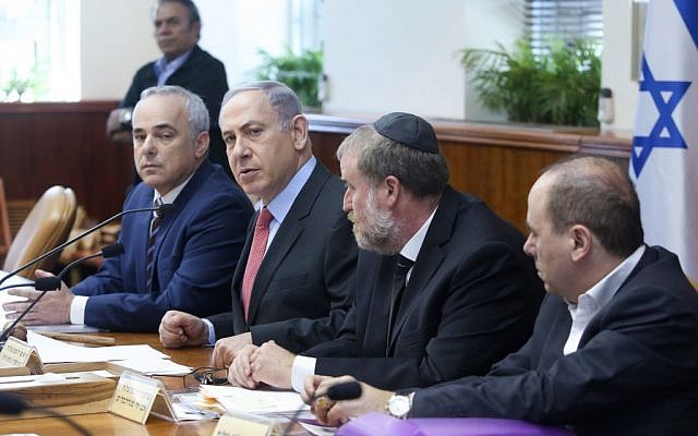 Prime Minister Benjamin Netanyahu, second left, and Minister Yuval Steinitz, left, attend the weekly cabinet meeting at Netanyahu's office in Jerusalem on August 16, 2015. (Marc Israel Sellem/POOL)