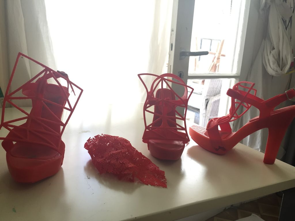 Red stiletto heels printed on a 3D printer for a fashion student's final project (Zahava Presser/Times of Israel)