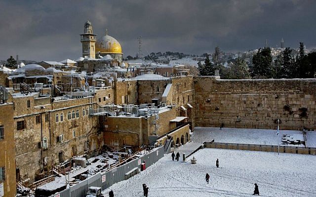 The Western Wall and the Dome of the Rock in Jerusalem, among the holiest sites respectively for Jews and Muslims, are covered in snow, December 13, 2013. (AP/Dusan Vranic, File)