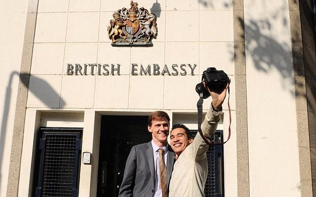British Ambassador to Egypt, John Casson, poses for a selfie with an Egyptian photographer at the entrance to the British embassy in Cairo, Egypt, Dec. 16, 2014 (AP Photo/Mohammed Asad, File)