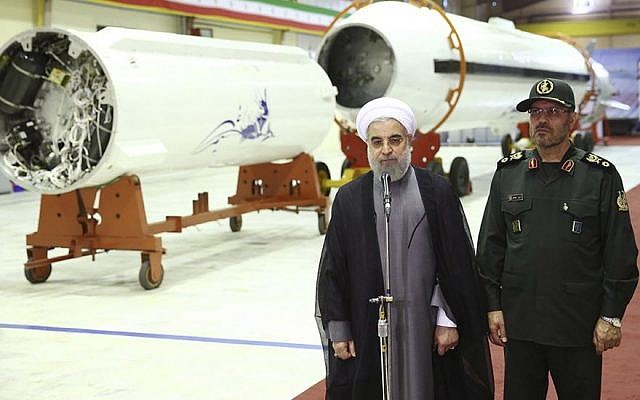 Iran's President Hassan Rouhani, left, briefs the media as Defense Minister Hossein Dehghan listens after unveiling the surface-to-surface Fateh-313, or Conqueror, missile in a ceremony marking Defense Industry Day, Iran, August 22, 2015. (Iranian Presidency Office via AP)