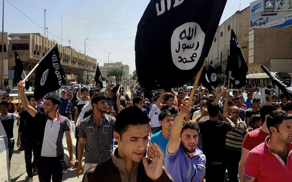 Illustrative photo of demonstrators chanting pro-Islamic State slogans as they carry the group's flags in front of the provincial government headquarters in Mosul, Iraq, June 16, 2014. (AP, File)