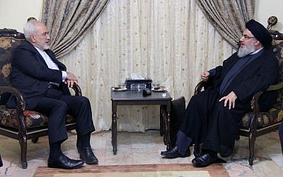 In this picture released by the Hezbollah media department, Hezbollah leader Hassan Nasrallah, right, meets with Iranian Foreign Minister Mohammad Javad Zarif, left, in Beirut, Lebanon, Wednesday, Aug. 12, 2015. (Hezbollah Media Department via AP)
