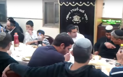 A festive meal inside Givat Ze'ev's Ayelet Hashahar synagogue (YouTube screenshot)