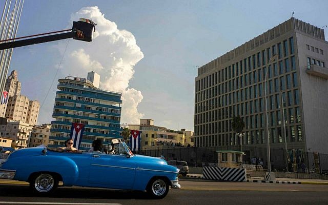 Tourists ride on a vintage American car in front of the US embassy in Havana, Cuba, Thursday, Aug. 13, 2015. (AP Photo/Ramon Espinosa)