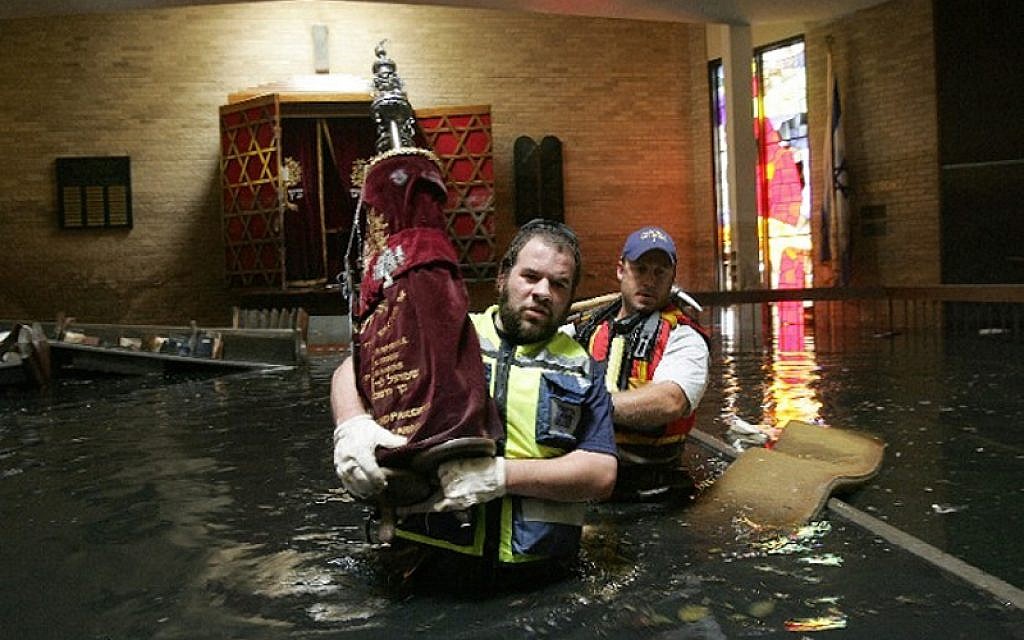 Members of ZAKA rescuing a Torah from Congregation Beth Israel after Hurricane Katrina hit, August 2005. (Courtesy ZAKA)