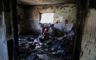 Inside the room of the Dawabsha home in Duma. A doll wrapped in a Palestinian flag rests in a stroller to honor Ali. (Eric Cortellessa/Times of Israel)