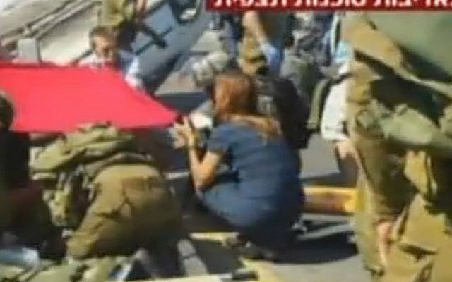 Rescue personnel and security forces attend the scene of a terror attack in the West Bank on Thursday, August 6, 2015. (screen capture: Channel 2)