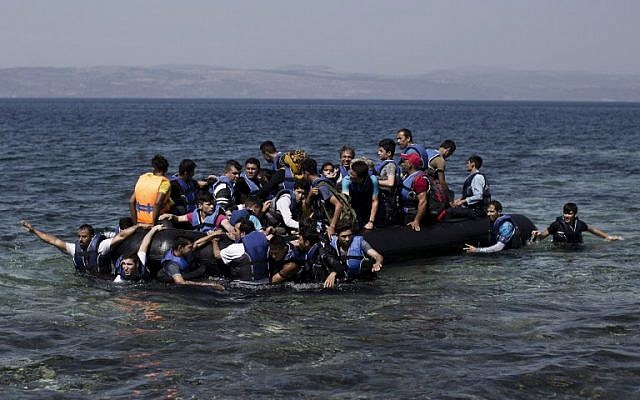 Illustrative: Syrian refugees arrive on the shores of the Greek island of Lesbos after crossing the Aegean Sea from Turkey on a inflatable dinghy, September 11, 2015. (AFP/ANGELOS TZORTZINIS)