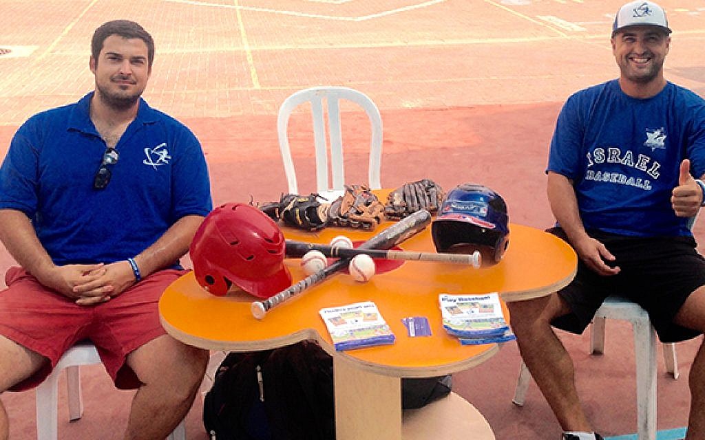 Nate Fish and Josh Scharff table at local Israeli schools to encourage youth to play baseball.
