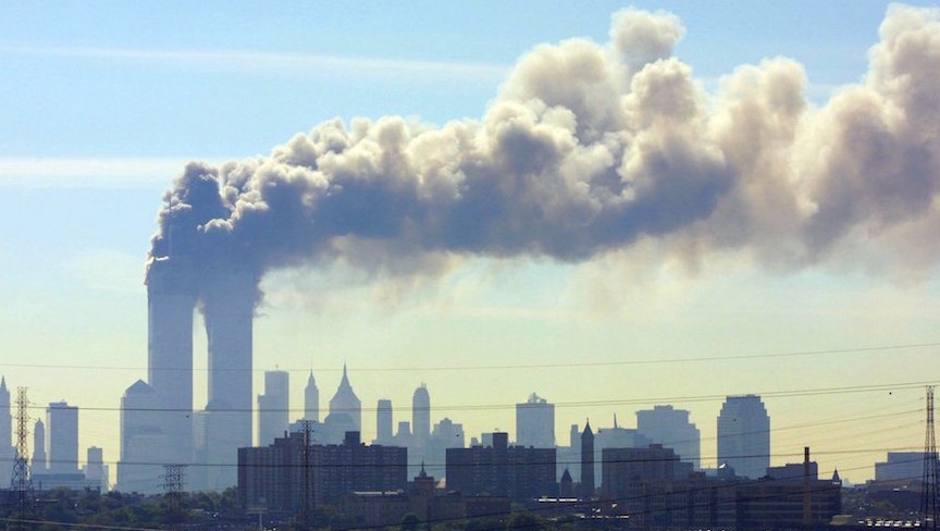 As seen from the New Jersey Turnpike, smoke billows from the Twin Towers of the World Trade Center in New York City after airplanes crashed into both towers, September 11, 2001. (JTA/AP/Gene Boyars)