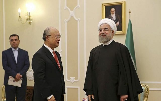 Iranian President Hassan Rouhani welcomes UN nuclear chief Yukiya Amano for their meeting in Tehran, Iran, Sunday, Sept. 20, 2015. (AP Photo/Vahid Salemi)