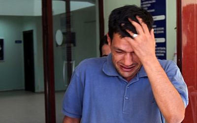 Abdullah Kurdi, 40, father of Syrian boys Aylan, 3, and Galip, 5, who were washed up on a beach near the Turkish resort of Bodrum on September 2, 2015, cries as he waits for the delivery of their bodies outside a morgue in Mugla, Turkey, on September 3, 2015. (AP/Mehmet Can Meral)