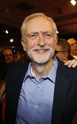 Jeremy Corbyn smiles as he leaves the stage after he is announced as the new leader of the UK opposition Labour Party during the Labour Party Leadership Conference in London, Saturday, Sept. 12, 2015. (AP/Kirsty Wigglesworth)