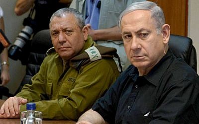 Prime Minister Benjamin Netanyahu sits with IDF Chief of Staff Gadi Eisenkot during a visit to the northern border of Israel on August 18, 2015. (Amos Ben Gershom/GPO)