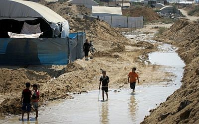Palestinians inspect the damage after Egyptian forces flooded smuggling tunnels dug beneath the Gaza-Egypt border, in Rafah in the southern Gaza Strip, on September 18, 2015. (Abed Rahim Khatib/ Flash90)