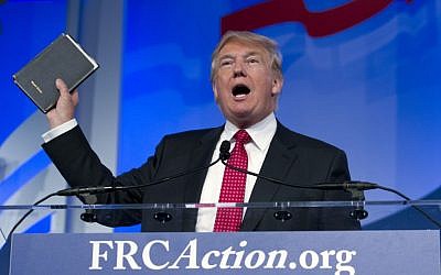 Republican presidential candidate, businessman Donald Trump, holds up a Bible given to him by his mother as he speaks during the Values Voter Summit, held by the Family Research Council Action, Friday, Sept. 25, 2015, in Washington (AP Photo/Jose Luis Magana)