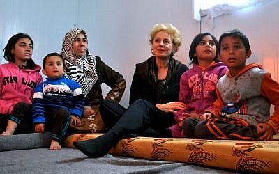 Dr. Georgette Bennett, head of the Multifaith Alliance for Syrian Refugees, with a family in Jordan's Za'arati refugee camp in February 2015. (courtesy)