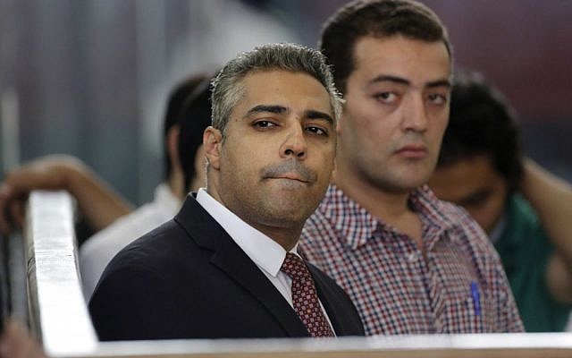 In this Thursday, June 4, 2015 file photo, Canadian Al-Jazeera English journalist Mohamed Fahmy, left, and his Egyptian colleague Baher Mohammed listen in a courtroom in Tora prison in Cairo, Egypt. (AP/Amr Nabil)