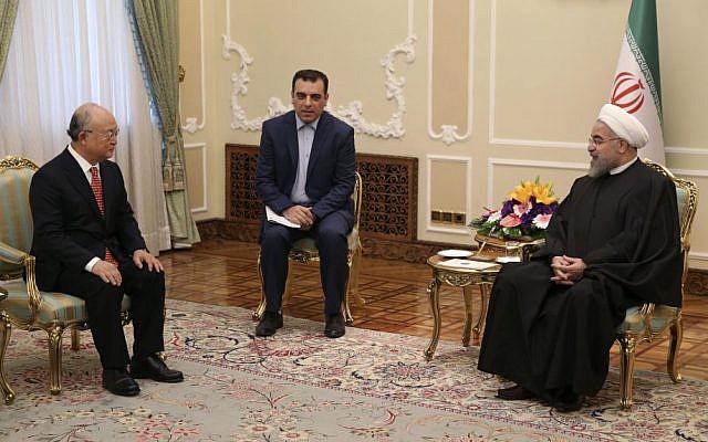 Iranian President Hassan Rouhani, right, talks with U.N. nuclear chief Yukiya Amano, left, during their meeting in Tehran, Iran, Sunday, Sept. 20, 2015. (AP Photo/Vahid Salemi)