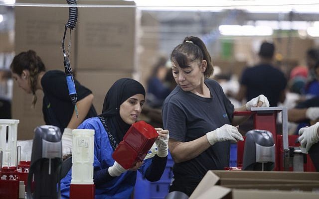Employees work at the new SodaStream factory in Israel's Negev Desert, next to the city of Rahat, Wednesday, Sept. 2, 2015. (AP/Dan Balilty)