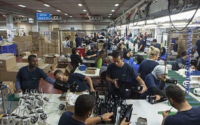 Employees work at the SodaStream factory built deep in Israel's Negev Desert next to the city of Rahat, Israel, September 2, 2015. (AP/Dan Balilty)