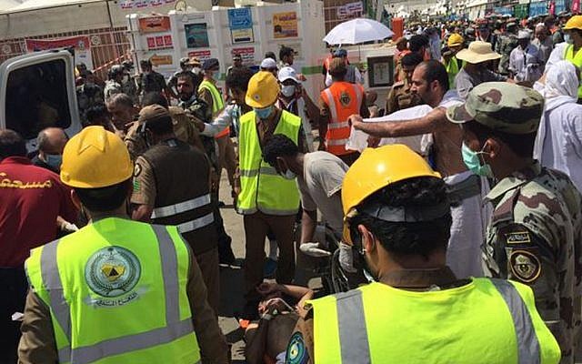 In this image posted on the official Twitter account of the directorate of the Saudi Civil Defense agency, rescuers respond to a stampede that killed and injured pilgrims in the holy city of Mina during the annual hajj pilgrimage on Thursday, Sept. 24, 2015. (Directorate of the Saudi Civil Defense agency via AP)