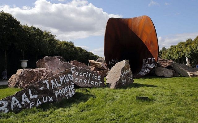 The sculpture 'Dirty Corner' by British-Indian artist Anish Kapoor in the gardens of the Palace of Versailles, near Paris was spray-painted with anti-Semitic graffiti on September 6, 2015. The French phrase in center reads: 'Bloody sacrifice' (Christophe Ena/AP)